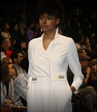 Model in an ivory tailored dress on the runway